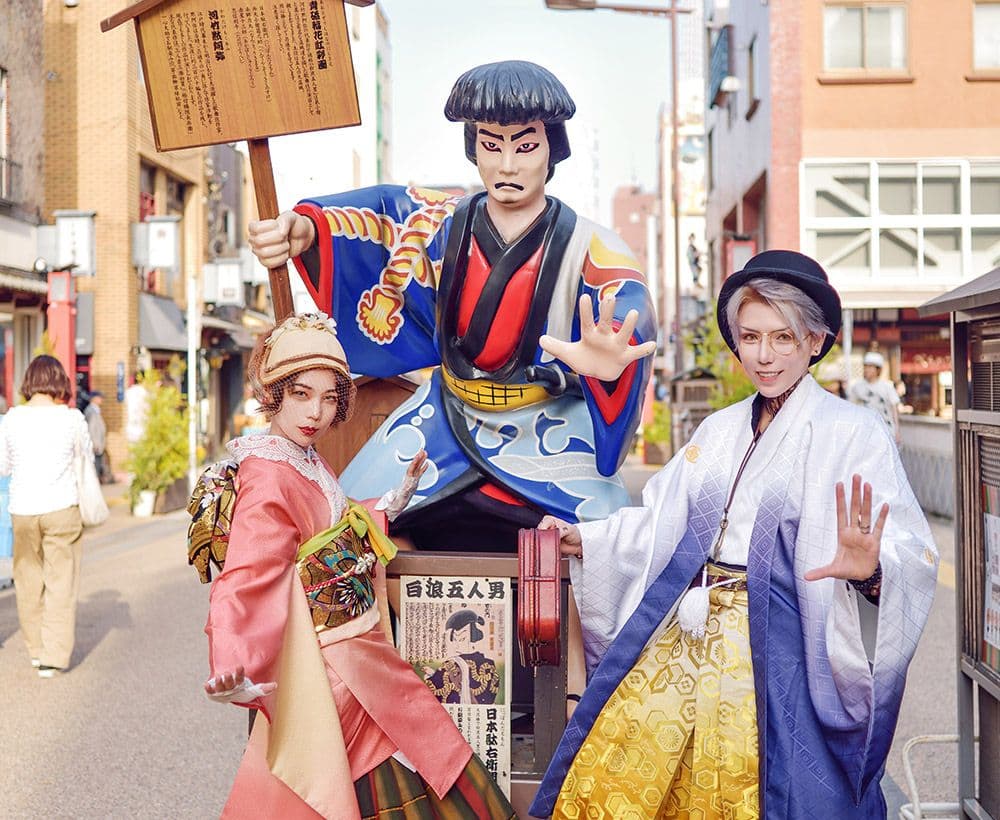 Exploring Asakusa in a Kimono – A Unique Way to Experience Tokyo  Asakusa, one of Tokyo’s most popular tourist spots, is loved by foreigners. While it’s fun to casually stroll around in your everyday clothes, wearing a kimono—an outfit you rarely get to try—can completely transform your mood and appearance. However, some might feel they don’t own a kimono or find the idea of wearing one more daunting than donning a yukata. That’s where kimono rental services come in, offering an accessible way for everyone to enjoy the experience. With a wide variety of patterns and styles, this service is designed for all.  Enjoy Kimono Without Lifting a Finger! In recent years, kimono rental shops that allow you to wander famous tourist spots in full kimono have become very popular.  In Asakusa—one of Tokyo’s renowned landmarks—you can find several rental shops near the station. These shops offer an extensive selection ranging from chic, understated designs to bold, modern patterns.  Although reservation methods may vary by store, most rental sets include everything you need for dressing up (such as the kimono, obi, and other essentials), and some even offer cute accessory rentals. With professional dressing services provided on-site, even those without prior experience can enjoy wearing a kimono with ease.  Not only do these services offer women’s kimonos, but some shops also provide men’s kimonos—making it an excellent option for groups or couples. Renting a kimono and strutting through the streets in a completely different look can turn your sightseeing into a uniquely stylish experience.  Discover Photogenic Spots! When one thinks of Asakusa, the image of Kaminarimon (Thunder Gate) often comes to mind. The large lantern that adorns this landmark is a classic photo spot. As this is a popular tourist destination with crowds even on weekdays, those wishing to explore or photograph at a leisurely pace are advised to visit in the morning.  From Kaminarimon, take a slow stroll along Nakamise Street on your way to Senso-ji Temple. This shopping street, lined with numerous shops, exudes a nostalgic atmosphere with many famous confectionery and traditional craft stores. It’s also the perfect place to sample Japanese sweets and snacks while enjoying the ambiance with your rented kimono.  After sightseeing, be sure to visit Senso-ji Temple—Tokyo’s oldest temple—and try your luck with an omikuji (fortune slip).  Experience the Town of Comedy Asakusa is also known as a town of laughter. Around Rokuku Street, you’ll find many comedy theaters, and you might even see young comedians handing out flyers, adding to the lively atmosphere.  In front of Asakusa Engei Hall—often hailed as the hall of comedy—vibrant banners adorn the area, making it a great spot for photos. Additionally, in front of the Asakusa Public Hall, there’s a “Star Plaza” lined with handprints and autographs of many celebrities. From Showa-era megastars to veteran comedians, the array of celebrity handprints offers a fun photo opportunity when you pose alongside them.  After fully enjoying the streets in your rented kimono, consider taking a walk to Sumida Park. From there, the view of Tokyo Skytree is simply unbeatable. Why not capture a commemorative photo with the Skytree while dressed in your radiant kimono?  Conclusion Kimono rental services allow even beginners to easily experience wearing a kimono, with professional dressing assistance ensuring a worry-free experience. Since application methods and packages vary by store, it’s recommended to check the details before using the service.  Wearing a kimono that’s a departure from your everyday casual attire and strolling through the historically and culturally rich streets of Asakusa will undoubtedly leave you with unforgettable memories. Whether with friends, as a couple, or in a group, take your time to explore and enjoy this unique experience.